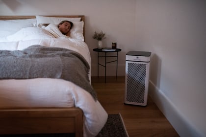 Woman sleeping near purifier